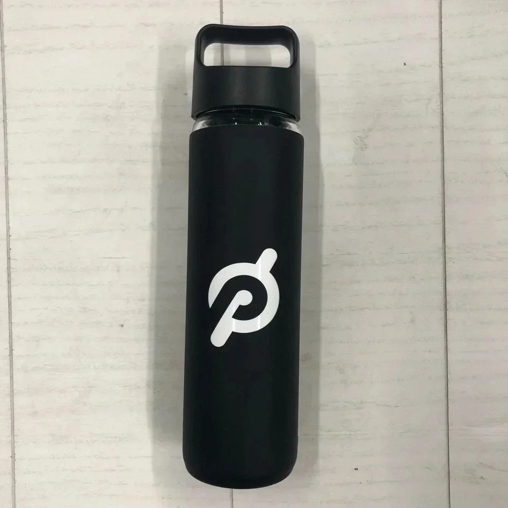 Peloton‎ Glass Water Bottle with Black padded material around glass with logo.